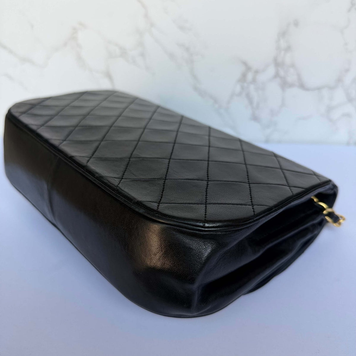 Corners of original Chanel black lambskin shoulder bag